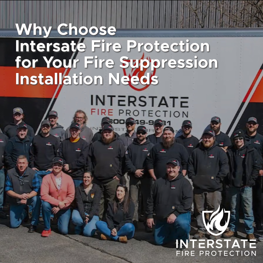 A team of Interstate Fire Protection employees standing and sitting in front of a branded company truck, symbolizing their commitment to fire suppression installation services. The title reads, "Why Choose Interstate Fire Protection for Your Fire Suppression Installation Needs," with the Interstate Fire Protection logo in the bottom right corner.